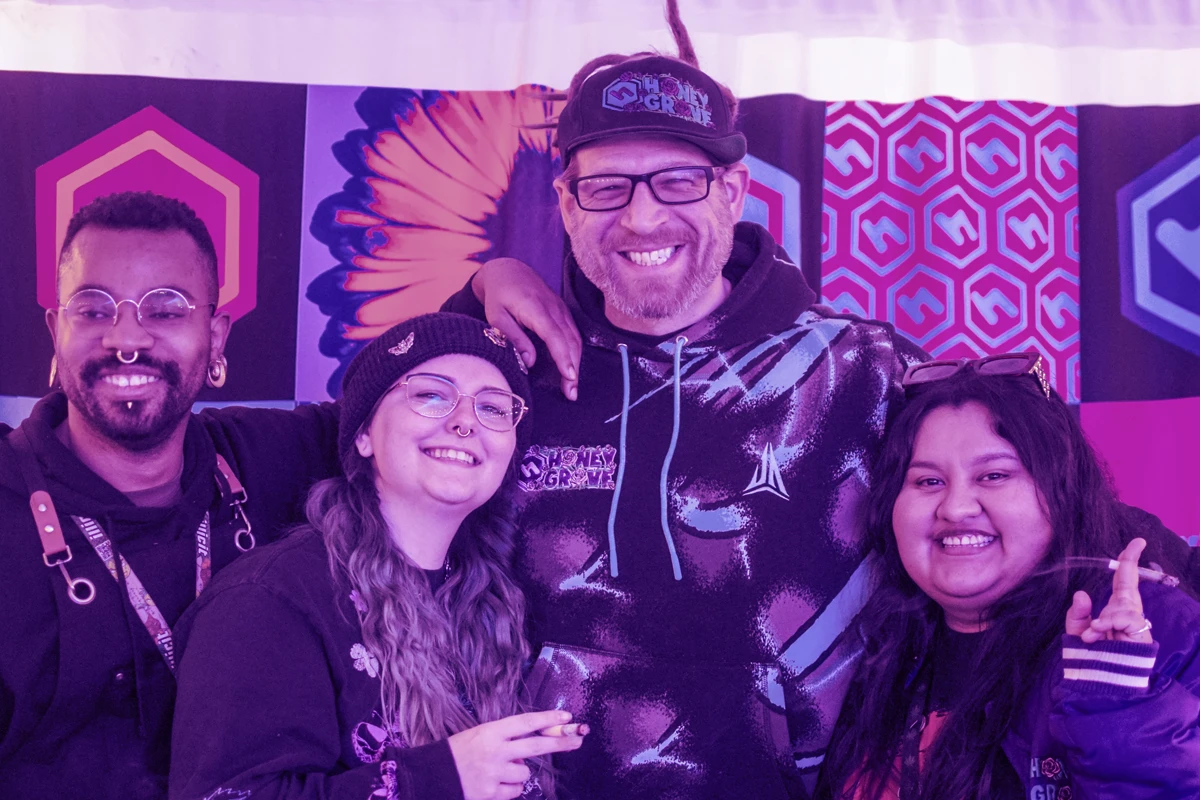 Four HoneyGrove employees smiling and posing in a photograph.